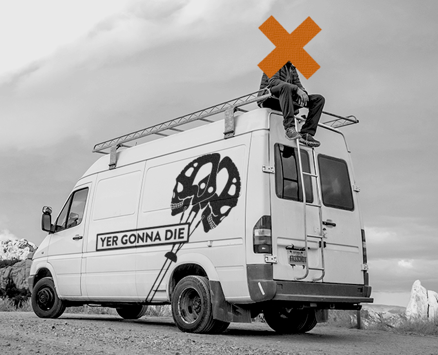 Man sitting on a branded 2005 Sprinter with a large yer gonna die climbing logo